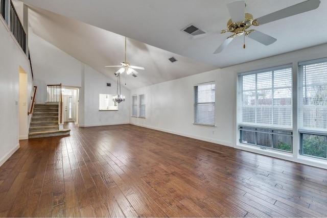 unfurnished living room with plenty of natural light, dark hardwood / wood-style flooring, and ceiling fan with notable chandelier