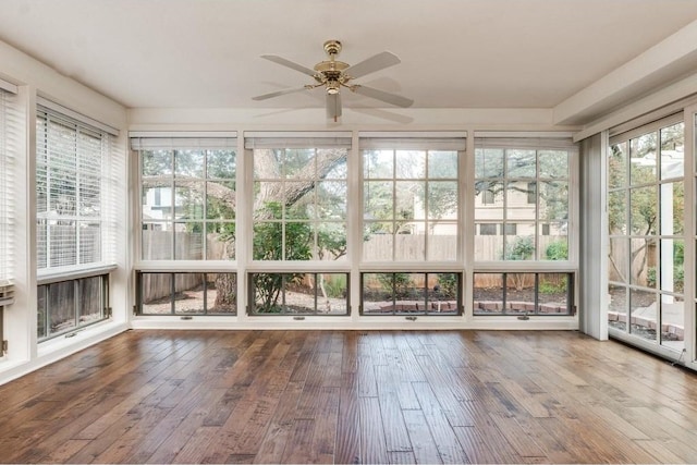 unfurnished sunroom featuring ceiling fan