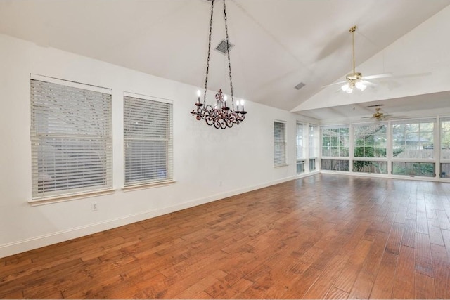 unfurnished room featuring hardwood / wood-style flooring, ceiling fan with notable chandelier, and vaulted ceiling