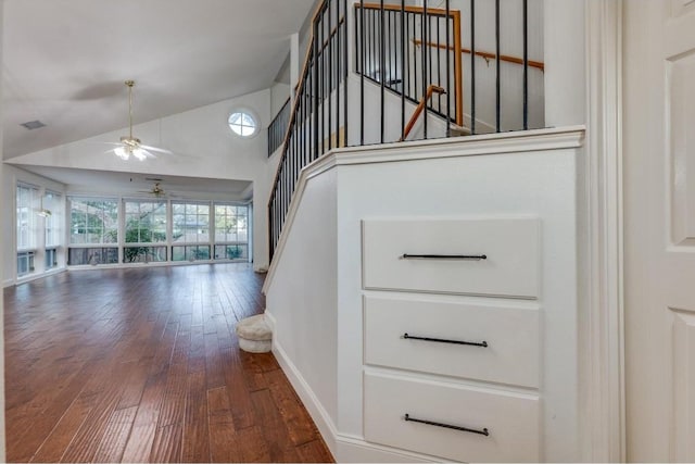 stairway featuring hardwood / wood-style floors, ceiling fan, and lofted ceiling