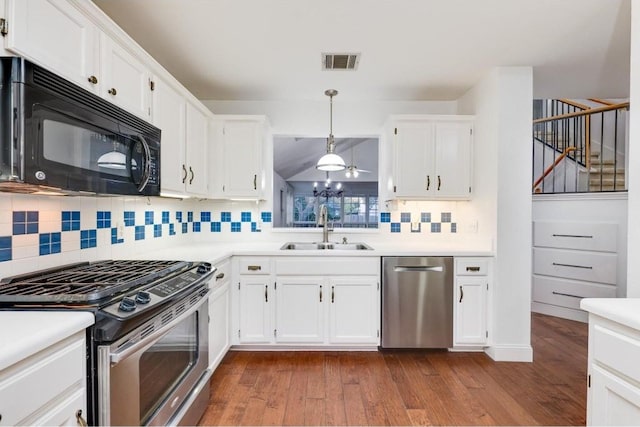 kitchen with sink, hanging light fixtures, stainless steel appliances, backsplash, and white cabinets