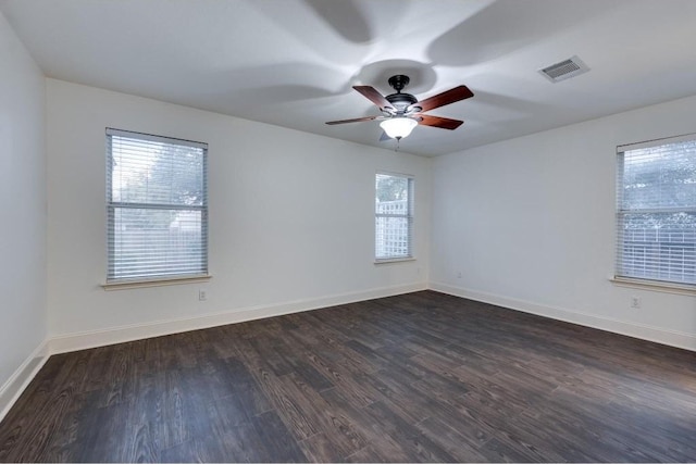 empty room featuring ceiling fan and dark wood-type flooring