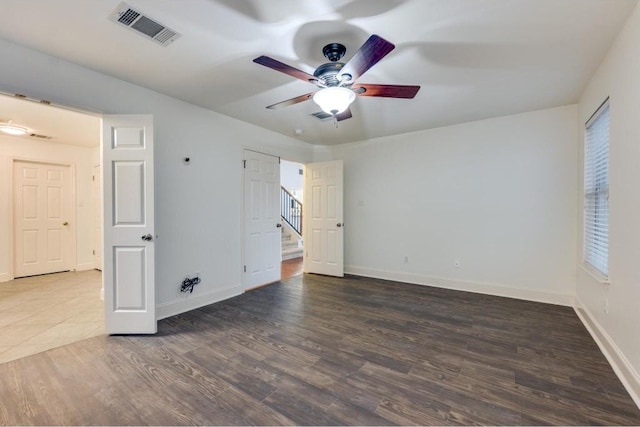 unfurnished bedroom featuring ceiling fan and dark hardwood / wood-style floors