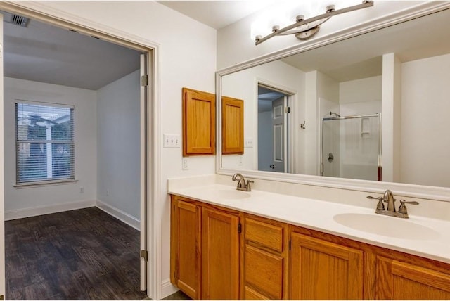 bathroom with vanity, wood-type flooring, and an enclosed shower