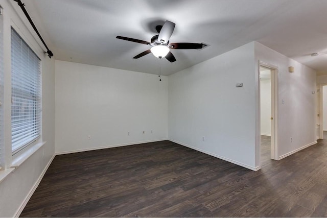 unfurnished room featuring ceiling fan and dark hardwood / wood-style floors