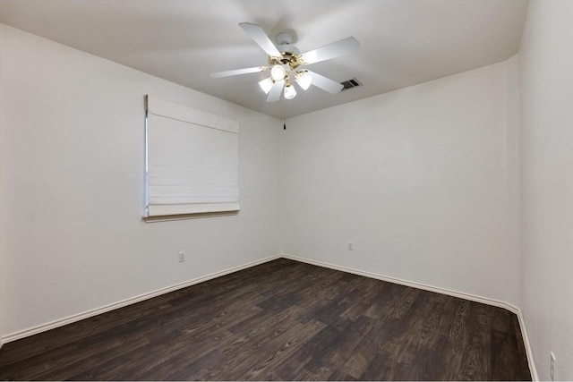 spare room featuring dark hardwood / wood-style flooring and ceiling fan