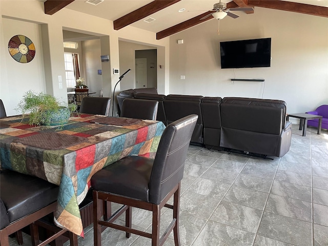 dining space featuring lofted ceiling with beams and ceiling fan