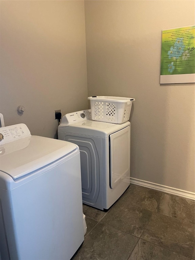 clothes washing area featuring independent washer and dryer