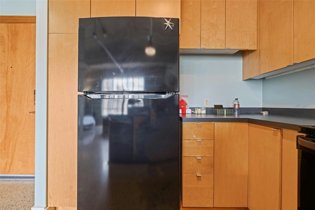 kitchen featuring black fridge