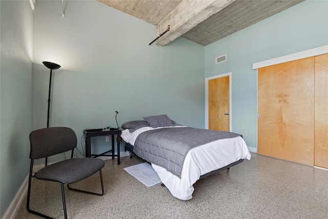 bedroom featuring a towering ceiling