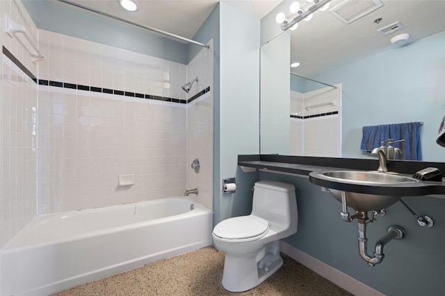 710 Colorado St Unit 5F, Austin, TX 78701 - full bathroom featuring speckle patterned floor, toilet, tub / shower combination, and baseboards