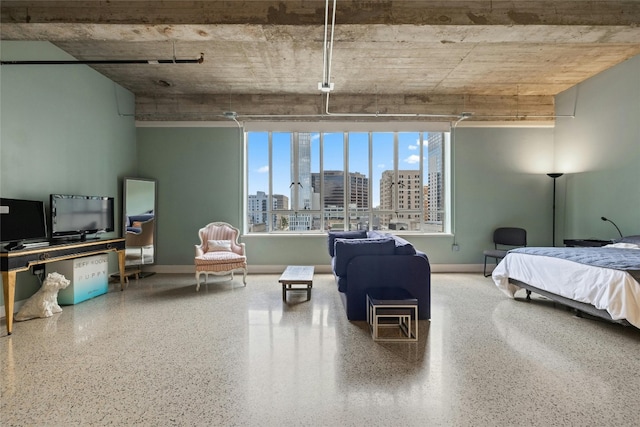 710 Colorado St Unit 5F, Austin, TX 78701 - bedroom featuring speckle patterned floor, a city view, and baseboards