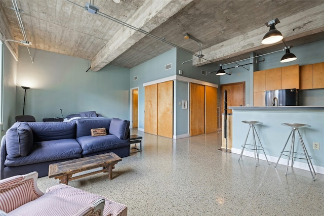 710 Colorado St Unit 5F, Austin, TX 78701 - living area with a towering ceiling, dark speckled floor, and baseboards