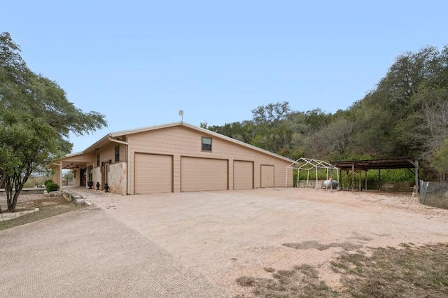 view of side of home with a carport and an outdoor structure