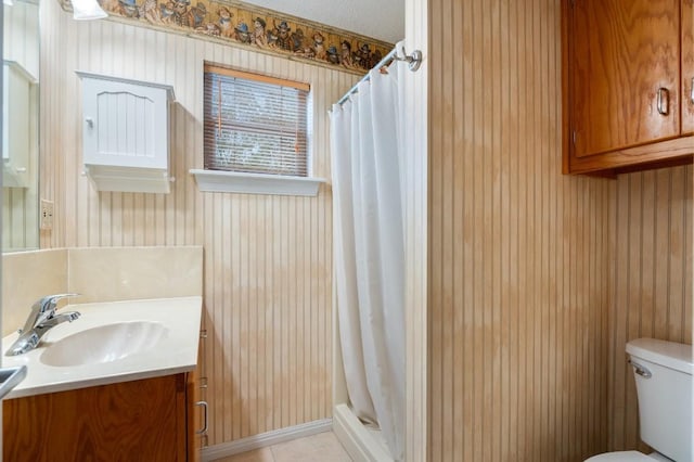 bathroom featuring vanity, toilet, and walk in shower