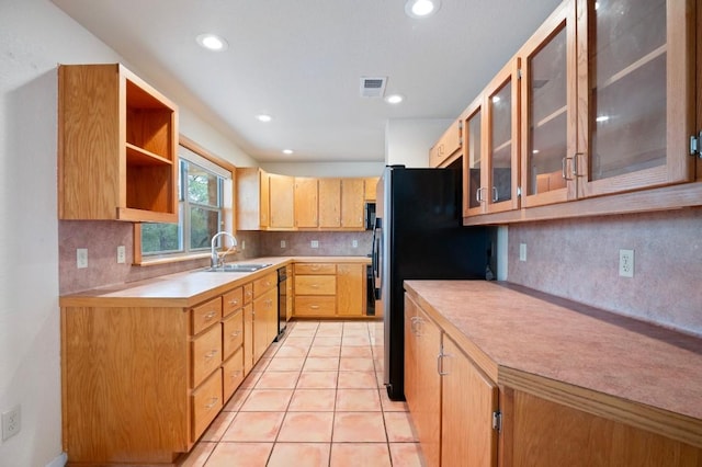 kitchen featuring tasteful backsplash, black appliances, sink, light brown cabinets, and light tile patterned flooring