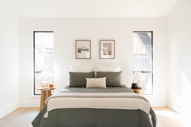 bedroom featuring light wood-type flooring and multiple windows