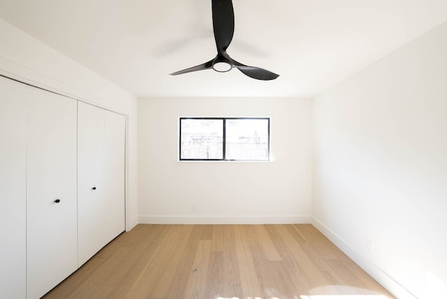 unfurnished bedroom with ceiling fan, light hardwood / wood-style floors, and a closet