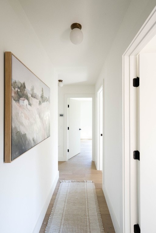 corridor with light wood-type flooring