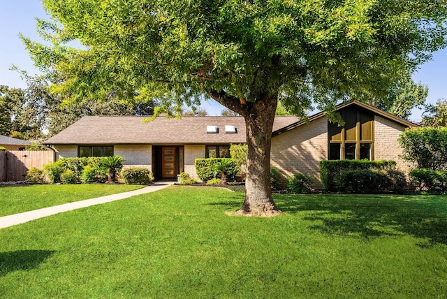 ranch-style home featuring a front yard