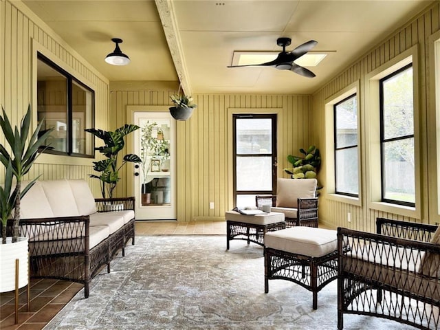 sunroom / solarium featuring ceiling fan