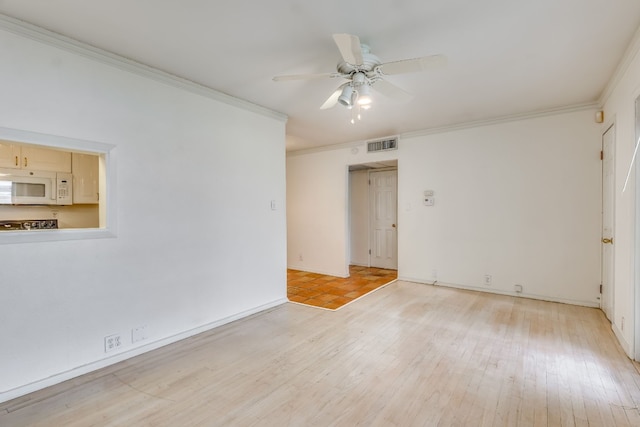 empty room with light hardwood / wood-style floors, ceiling fan, and crown molding