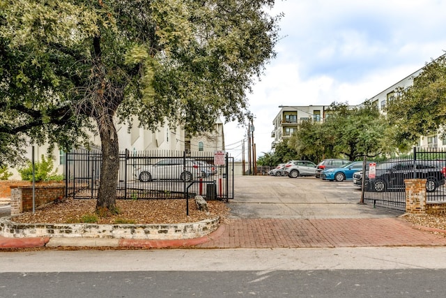 910 Duncan Ln Unit 50, Austin, TX 78705 - view of asphalt street featuring a gated entry and curbs