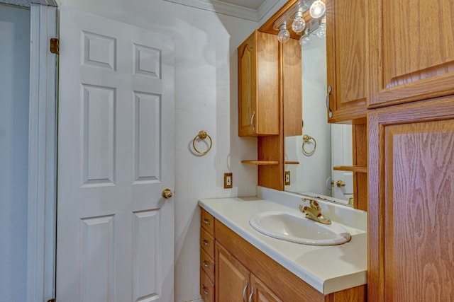 bathroom with vanity and ornamental molding