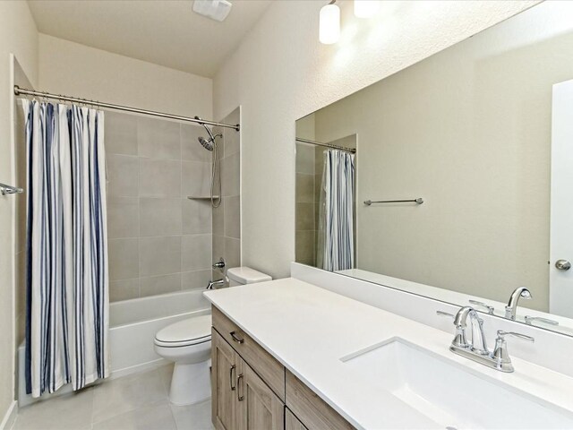 full bathroom with shower / bath combination with curtain, tile patterned flooring, vanity, and toilet