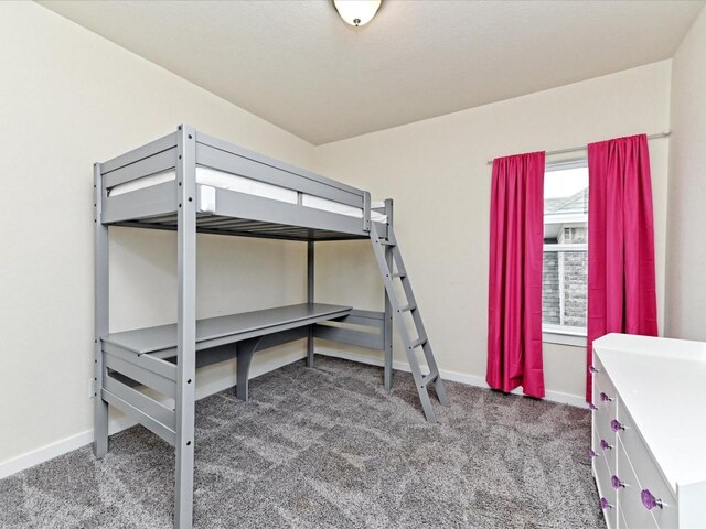 carpeted bedroom featuring baseboards