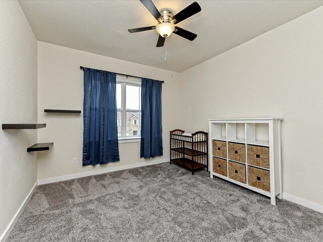 carpeted bedroom featuring ceiling fan and baseboards