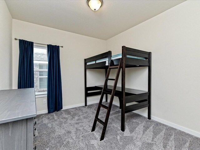 bedroom with baseboards and carpet flooring