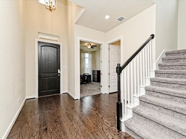 foyer featuring a notable chandelier and dark hardwood / wood-style floors