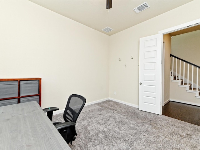 carpeted office featuring ceiling fan, visible vents, and baseboards