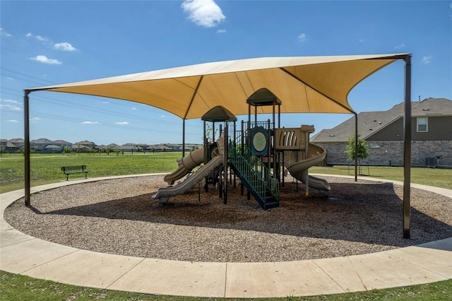 community jungle gym with a lawn and central air condition unit