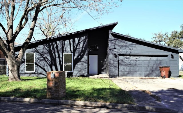 view of front of home featuring a garage and a front lawn