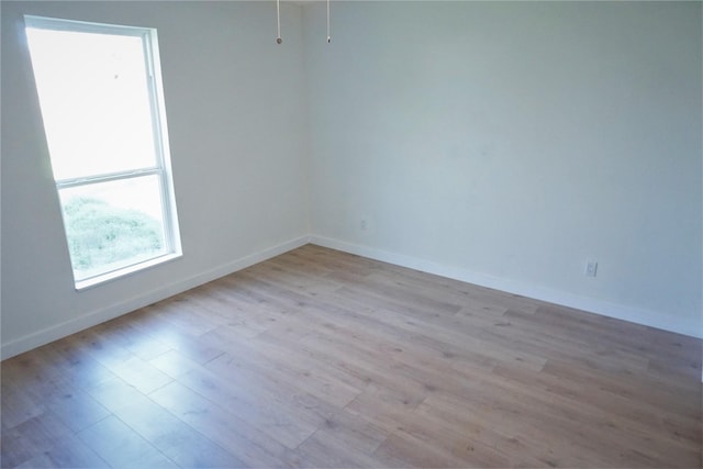 spare room with light wood-type flooring