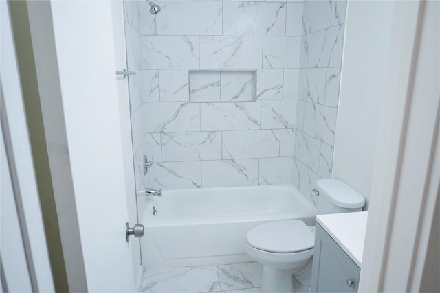 full bathroom featuring tiled shower / bath, vanity, and toilet