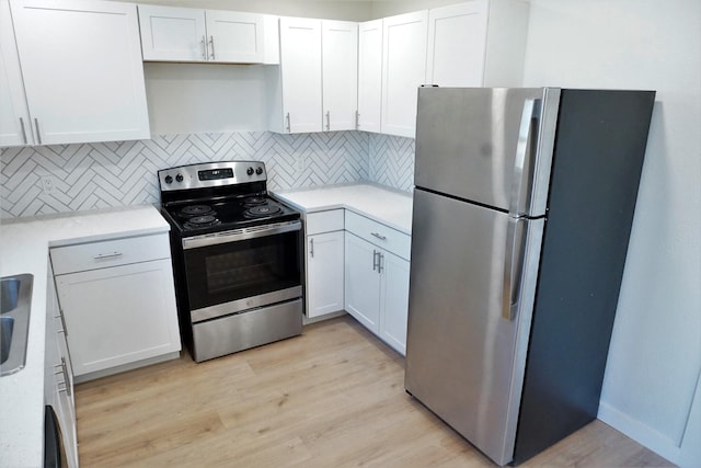 kitchen featuring tasteful backsplash, light hardwood / wood-style flooring, stainless steel appliances, and white cabinets