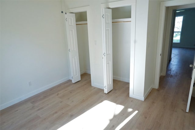 unfurnished bedroom featuring light hardwood / wood-style floors and a closet