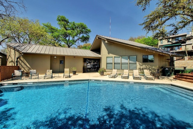 back of property with a community pool