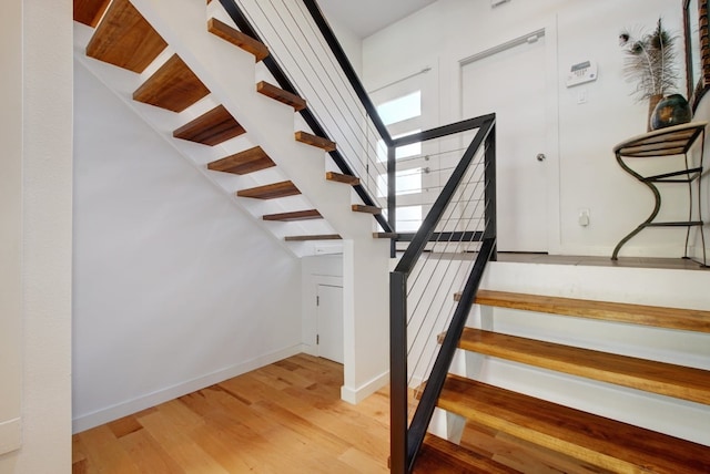 stairway with hardwood / wood-style floors