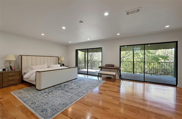 bedroom featuring light wood-type flooring and access to outside