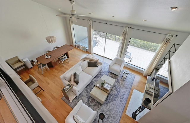 unfurnished living room with wood-type flooring and ceiling fan