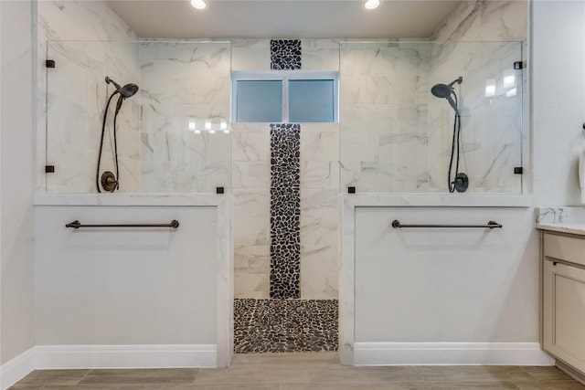 bathroom featuring recessed lighting, a marble finish shower, vanity, and wood tiled floor