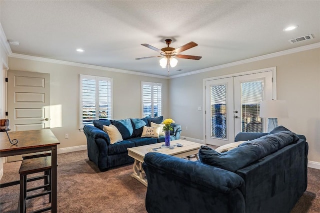 living room featuring baseboards, visible vents, dark colored carpet, and ornamental molding