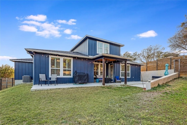 back of house with central AC unit, a fenced backyard, a lawn, board and batten siding, and a patio area