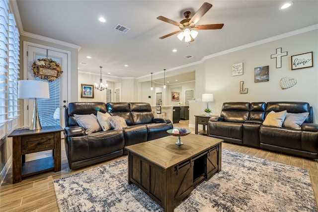 living room with ornamental molding, light wood-type flooring, visible vents, and recessed lighting