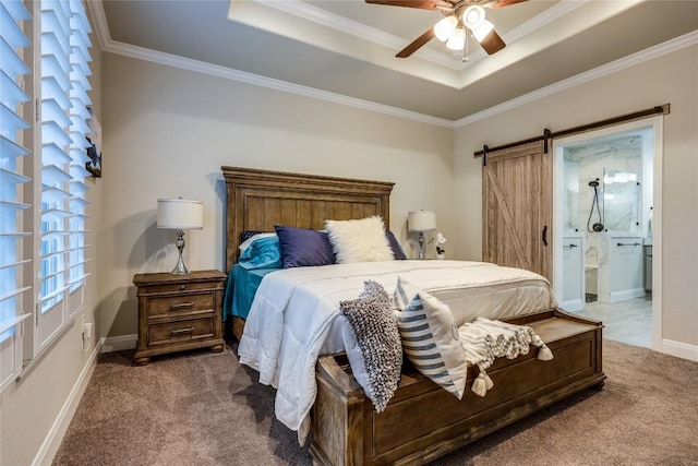 carpeted bedroom with ornamental molding, a barn door, a raised ceiling, and baseboards