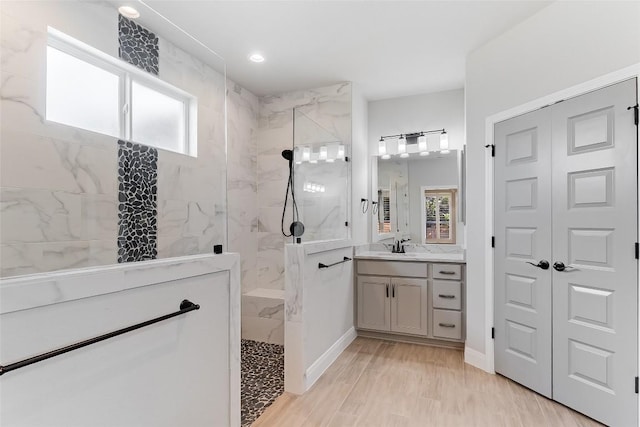 20104 Byrd Ave, Lago Vista, TX 78645 - bathroom featuring a marble finish shower, vanity, and healthy amount of natural light